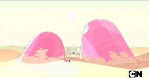 Pink diamond's leg ship buried by the sand.