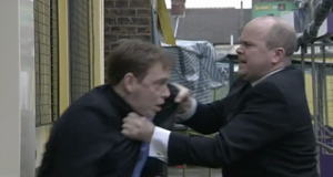 Phil attacks Ian in the square prior to getting shot (2001).