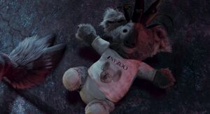The wildebeest toss the koala doll at Kazar's hooves.
