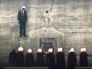 Putnam's body hanging on the wall.