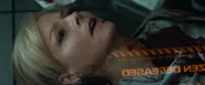 Delacourt slowly bleeds from her injury and dies.