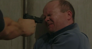 Phil flinches as Dan pulls the trigger of the gun (2001).