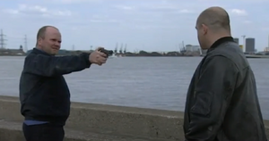 Phil prepares to shoot Grant when the latter dares him to do that during their argument.