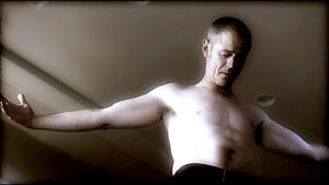 Foyet showing Hotch his self-inflicted scars.