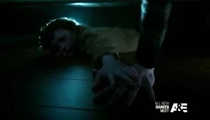 A young Norman holds his mother's hand as his father is raping her.