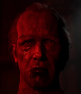 A close-up of Frank's unmasked face.