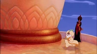 Jafar watching the Sultan rush to welcome Prince Ali into the palace.