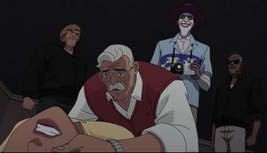 Joker watches as Gordon cradles his daughter.