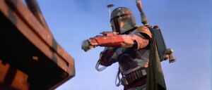 Boba preparing to use his wrist gun.