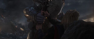 Thor stops Thanos' attack.