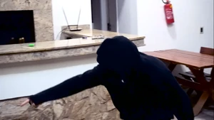 The Invader threatening Rezende to kill him if he doesn't leave the house