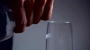 The Invader fills Virginia's glass with wine...