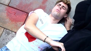Rezende pushes The Invader's body off him, revealing The Invader to be finally dead
