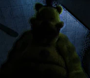 Fredbear staring down at the worker