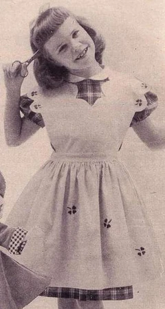 This photo is from the Fall-Winter 1952-53 issue of McCall's Needlework. McCall's 1717 includes a "matching" outfit for dolls. Notice the child is holding scissors to her head.