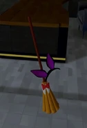 Broom with a bunny-girl headband.
