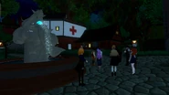 The townsfolk relaxing in the town square at night.