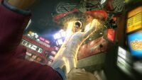 Kazuma beating Yuya with a motorcycle (Yakuza Kiwami, the HD remake of the first Yakuza game)