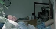 A soldier checks Rick's room for signs of the infected.