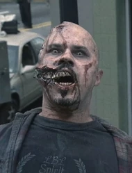 Shovel Walker by Brian Stretch Atlanta, Georgia As Rick exits the tank, he kills the walker with a shovel and it slowly falls down dead.