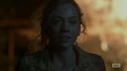 Beth walking away from the fire in episode still