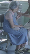 Elderly woman with gray hair, seen dead in deleted scene - see additional image