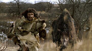 A male Neanderthal being chased by a  ()