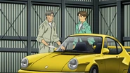 A parked yellow 911 (964) Carrera RS 3.8. in Kitami's warehouse in anime