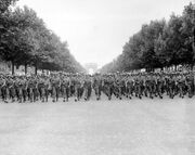 American troops march down the Champs Elysees