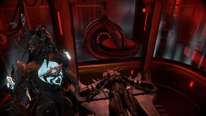 The Grineer Soldier in the Red Veil Binding, with Infested nearby.