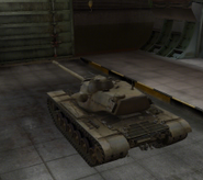 A rear left view of a T110E5 in a garage