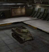 A front right view of a M8A1 in a garage