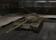 A front right view of a T110E5 in a garage