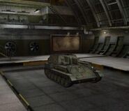 A front right view of a SU-85B in a garage