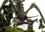A Tyranid Hierophant Bio-Titan moves through the forest.