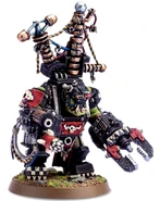 An Ork Big Mek wearing Mega Armor and equipped with a Kustom Force Field generator.