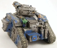 A looted Leman Russ Demolisher as seen from the rear; a Gretchin is used to load the cannon