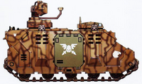Damocles Command Vehicles of the Raptors Chapter. This vehicle bears desert camouflage and crowned skull campaign badge of the Angelis Campaign. The winged skull symbol on the door is used to denote a command unit.