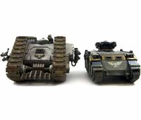 A Land Raider Proteus adjacent to a Razorback transport; the Proteus is on the left