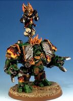 Bray'Arth Ashmantle, interred within the Iron Dragon Ironclad Dreadnought of the Salamanders Chapter, armed with twin Powerfists with in-built Dreadfire Pattern Heavy Flamers