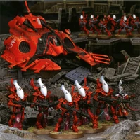 A line of Wraithguard protect their living brethren from harm. A Wave Serpent follows close behind.