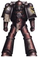 A Word Bearers Tactical Marine in Mark IV Power Armour during the Horus Heresy; note that this warrior has repainted his armour "Traitor's Red" from grey, inscribed it with passages from the Book of Lorgar in Colchisian runes and defaced the old icon of the XVIIth Legion, transforming it into the Latros Sacrum