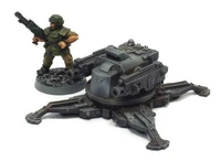 A lone Imperial Guardsman standing next to a Tarantula Sentry Gun for size comparison