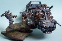 A Land Speeder Storm dropping off a squad of Space Marine Scouts