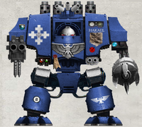 Brother Hakael, a Mars Pattern Mark IV Dreadnought of the Avenging Sons Chapter, armed with twin-linked Heavy Bolters and a Dreadnought Close Combat Weapon.