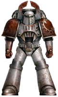 A World Eaters Assault Legionary during the middle years of the Horus Heresy; note the blood applied to the shoulder pauldrons obscures former Legion iconography; this Legionary's helm also possesses the twin mantles of the caedere remissum, the bladed horns which would become the trademark of the Khorne Berzerkers.