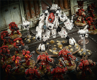 An XV95 Ghostkeel appears out of nowhere among the Blood Angels Space Marines.