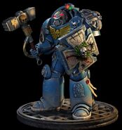 An Assault Terminator of the Ultramarines Chapter armed with a Storm Shield and a Thunder Hammer.