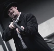 O'Brien in a trench coat with a shotgun in his own hands
