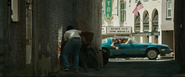 Mike hides from Henry in an alley.